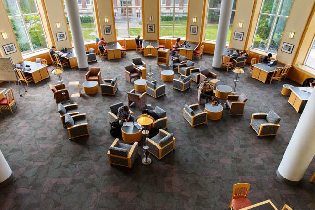 people studying in armchair in a sunny rotunda